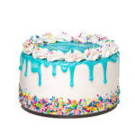 Vanilla buttercream birthday cake with a teal blue ganache drip and colorful sprinkles isolated on a pure white background. Trendy.